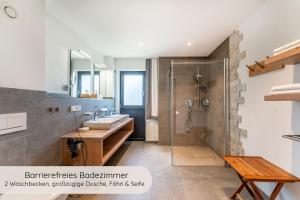 a bathroom with a shower and a sink at INVITA Natur-Chalets - Familienurlaub im Schwarzwald in Bad Dürrheim +124 photos