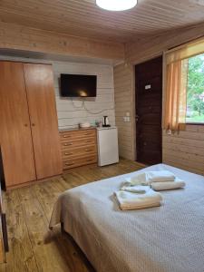 a bedroom with a bed with two towels on it at Agroturystyka U BOŻENY in Przysłup