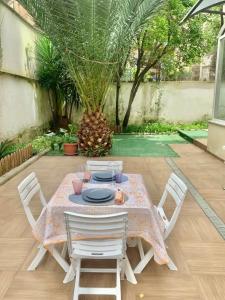 a table with four chairs and a table with at Luxury Vatican Home - Private Garden in Rome