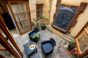 an overhead view of a patio with chairs and a table at Il-Kampnar Gozo Farmhouse with Private Pool in Sannat