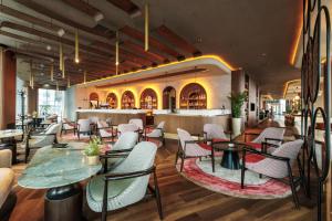 ein Restaurant mit Tischen und Stühlen und einer Bar in der Unterkunft Hotel Osijek in Osijek