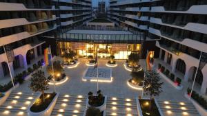 an aerial view of an apartment building at night at Eleven Odyssey Apartment in Năvodari