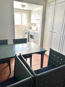 a kitchen with a dining room table and chairs at Vuohensaari, Rantatalo 6 in Salo