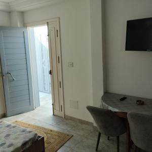 a bedroom with a bed and a desk and a television at Residence djerba 1 in Houmt Souk