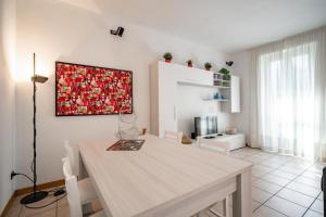 a dining room with a table and a painting on the wall at Dolce Teresa in Mandello del Lario +35 photos