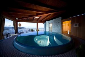 a jacuzzi tub in a house with a view at Mira Spiaggia in San Vito lo Capo