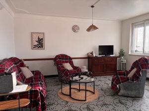 a living room with two chairs and a tv at Gîte Les Mirabelliers à Morville Hébergement cosy in Morville