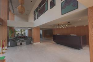 a lobby with a couch and a reception desk at Hotel Palacio Paltan Bazaar in Guwahati