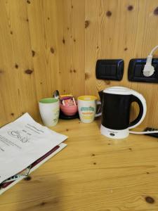 a table with three coffee cups on top of it at B&B Ledro AFFITTACAMERE in Mezzolago +27 photos