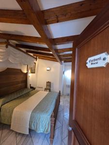 a bedroom with a bed and a sign on a wall at Antico Casale Russo in Piano di Sorrento
