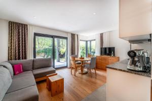 a living room with a couch and a table at INVITA Natur-Chalets - Familienurlaub im Schwarzwald in Bad Dürrheim
