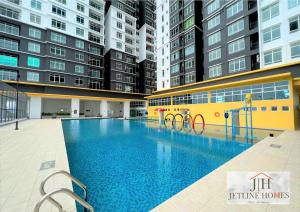 a large swimming pool in a building with tall buildings at Melaka Nova-8 Studio City-View-4pax in Malacca