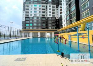 a swimming pool with a playground in front of some buildings at Melaka Nova-8 Studio City-View-4pax in Malacca