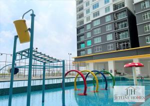 a pool with a water slide in front of a building at Melaka Nova-8 Studio City-View-4pax in Malacca +1 photo