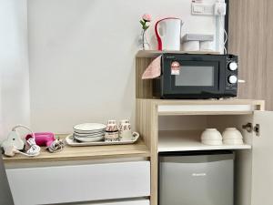 a microwave on a shelf next to a kitchen at Melaka Nova-8 Studio City-View-4pax in Malacca