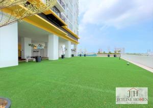 a large artificial lawn in front of a building at Melaka Nova-8 Studio City-View-4pax in Malacca