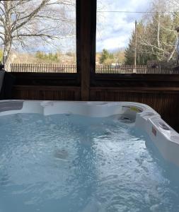 a jacuzzi tub in a house with a window at Bogatu Vendégház in Bogács