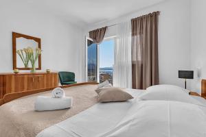 a bedroom with a large bed with a large window at Apartment Green Valley in Imotski