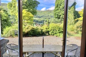 a view from the door of a table with a candle at The Coach House in Saint Fillans