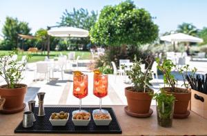 a table with two wine glasses and a tray of food at Tenuta San Nicola in Novoli +61 photos