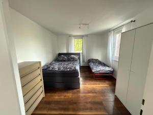 a room with two beds and a dresser in it at Tälealpakahof in Alpirsbach