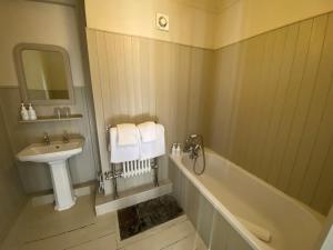 a bathroom with a sink and a bath tub and a sink at The Cavendish Arms in Cartmel +35 photos