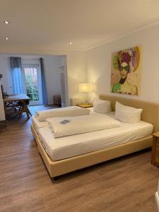 a bedroom with two beds and a painting on the wall at Landhotel Franck Garni in Brietlingen