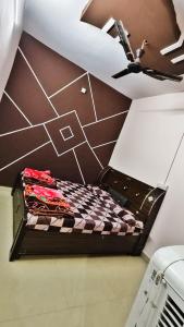 a bed in a room with a ceiling at Adiyogi Guest House in Ujjain