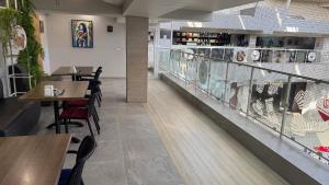 a restaurant with wooden tables and chairs and a counter at Hostel City Center in Chişinău