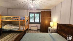 a bedroom with two bunk beds and a window at gite bertry in Eyburie +7 photos