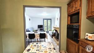 a kitchen with a table and chairs in a room at gite bertry in Eyburie