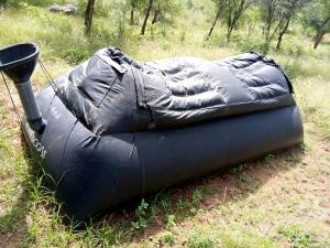 anlatablelatable raft laying on the grass in a field at Footprint Baringo in Marigat