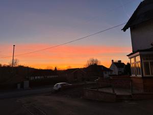 a sunset with a car parked on a street at Cavendish Hotel in High Wycombe