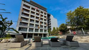 an image of a hotel with chairs and a pool at Soaltee Westend Lakeside Pokhara in Pokhara