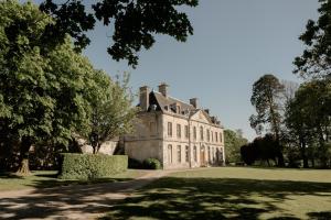 an old house with a tree in front of it at ABBAYE DE BLANCHELANDE in Neufmesnil
