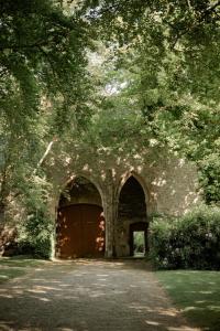 an entrance to a building with a large wooden door at ABBAYE DE BLANCHELANDE in Neufmesnil +20 photos