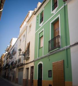 a green building on the side of a street at Casa Marifina in Enguera