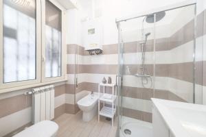 a bathroom with a shower and a toilet and a sink at Luxury Vatican Home - Private Garden in Rome