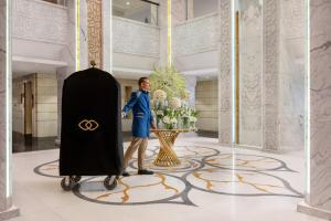 a man is standing next to a giant oscar sign in a room at Sofitel Shahd Al Madinah in Medina