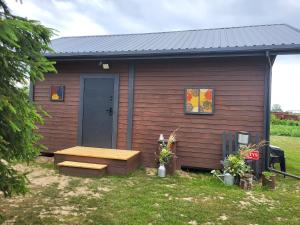 a small shed with a bench and a blue door at Domki u Sołtysa in Ciechocinek +5 photos