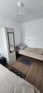a bedroom with a mirror and a bed with mats at Domki u Sołtysa in Ciechocinek