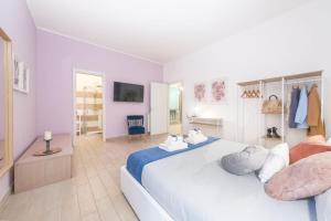 a bedroom with a large bed with towels on it at Luxury Vatican Home - Private Garden in Rome
