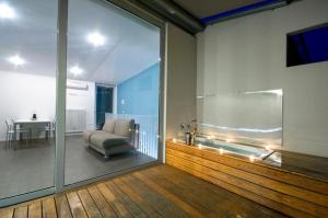 a living room with a couch and a sliding glass door at meckisapartment in Nago-Torbole