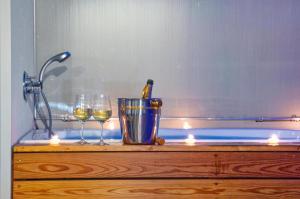 a table with two glasses of wine and candles at meckisapartment in Nago-Torbole +15 photos
