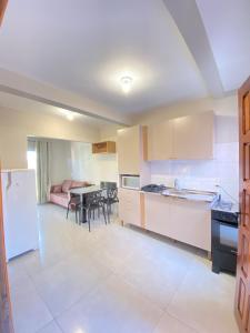 a kitchen with a table and a dining room at Casa da Simonia in Foz do Iguaçu +9 photos