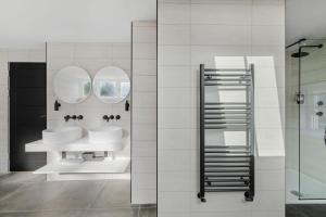 a bathroom with two sinks and two mirrors at Provident Suite - Free Wi-Fi - Sea View in Brixham