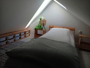 a bedroom with a bed in a attic at Baltic Park in Rozewie