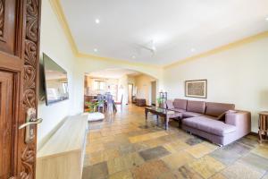 a living room with a couch and a table at Beat's Hideaway in Galu