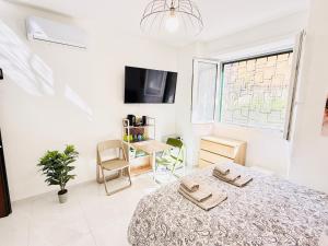 a bedroom with a bed and a table and a window at Vatican Town House in Rome