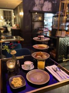 a table with plates and bowls of food on it at Poorter Boutique Hotel Brielle in Brielle